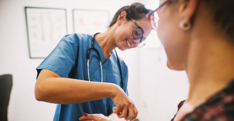 nurse giving treatment to patient